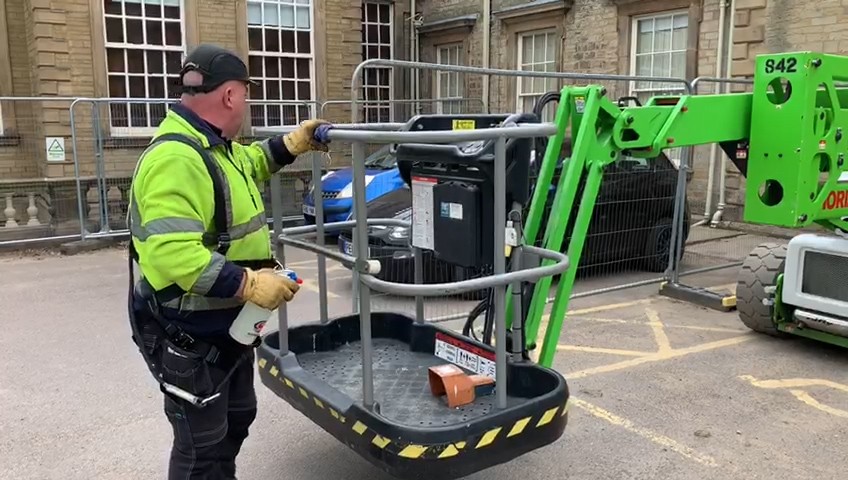 boom lift being checked before use