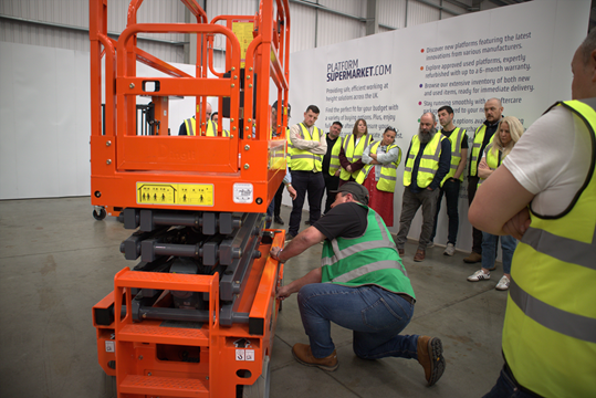 IPAF instructor showing emergency lowering on a scissor lift