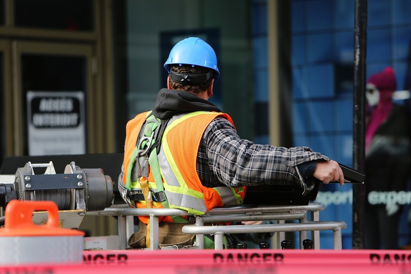 worker with harness on operating a cherry picker
