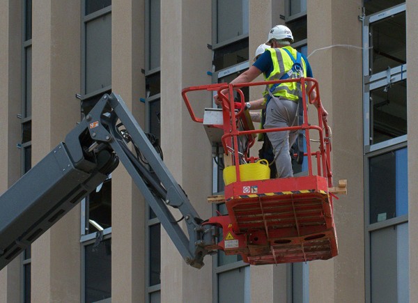 2 men working at height in a cherry picker