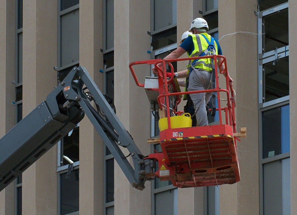 2 men working at height in a cherry picker